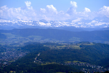 Aerial view of landscape at Canton Zürich with the Swiss Alps in the background seen from local mountain Uetliberg on a sunny spring day. Photo taken May 18th, 2022, Zurich, Switzerland.