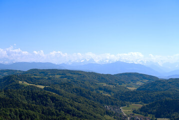 Fototapeta na wymiar Aerial view of landscape at Canton Zürich with the Swiss Alps in the background seen from local mountain Uetliberg on a sunny spring day. Photo taken May 18th, 2022, Zurich, Switzerland.
