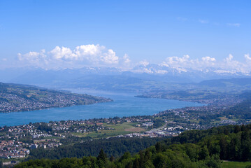 Aerial view of Lake Zürich and Canton Zürich with the Swiss Alps in the background seen from local mountain Uetliberg on a sunny spring day. Photo taken May 18th, 2022, Zurich, Switzerland.
