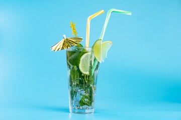 on a blue background Glass beverage ice mint mojito. refreshing citrus