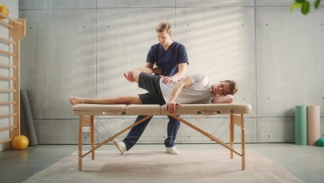 Sportsman Patient Undergoing Physical Therapy to Recover from Surgery and Increase Mobility. Physiotherapist Works on Specific Muscle Groups or Joints to Rehabilitate from Injury.