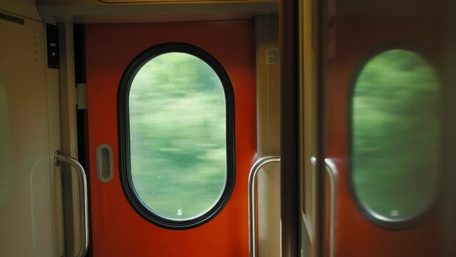 Bullet train rides on the railway track. Journey and trip on train. Interior view at train's empty window.