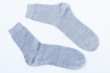 Pair of gray socks on white background.