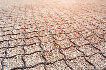 Geogrid used at base of new pedestrian road, road construction, reinforcement covered with fine gravel.