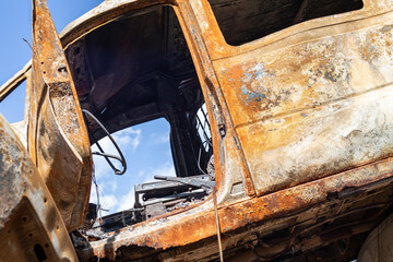 Broken and burned cars in the parking lot, accident or deliberate vandalism. Burnt car. Consequences of a car accident. Damaged by arson. Dump of civilian vehicles shot by Russian troops in Ukraine.