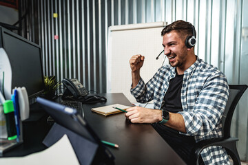 Customer service support operator man with headphones and microphone talking to client in call center