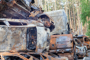 Rusty burnt cars destroyed by rocket explosions. War in Ukraine. Destroyed vehicles of civilians...