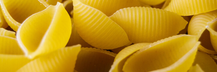 pasta Conchiglioni close-up. yellow pasta. pasta texture. Banner for insertion into site. Horizontal image