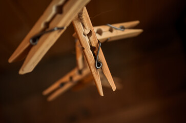 close-up wooden clothespins hanging on a natural jute linen rope photo in low key
