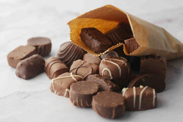 dark chocolate spilling from a paper packet 