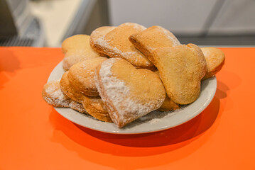 Cookies on a plate. Heart-shaped cookies. Cookies sprinkled with sugar pollen on the bar. Ukraine. Kyiv. May 19, 2016