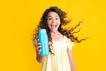 Child with shampoo conditioner. Daily cosmetic care. Teenager hold bottle of hair and skin care. Beauty health and cosmetics. Excited teenager, glad amazed and overjoyed emotions.