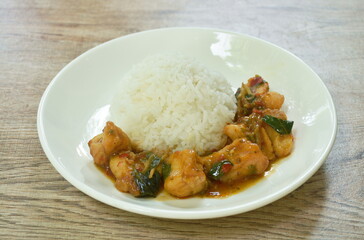 spicy stir fried bass fish with white finger root and chili with rice on plate