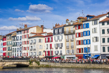 Paople on the quay of the Nive river in Bayonne, France