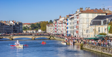 Panorama of people enjoying the sun while watching the boat race in Bayonne, France