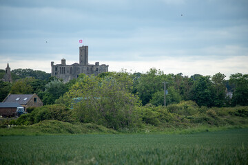 Fototapeta na wymiar View of medieval Warkworth Castle from afar 