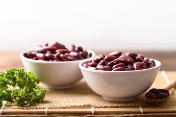 Red kidney beans in bowl on wooden table, Food ingredients