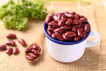 Red kidney beans in bowl on wooden table, Food ingredients