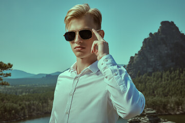 blond man in black sunglasses