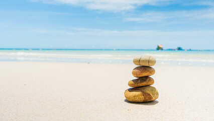 Fototapeta na wymiar Stones balanced on beach. Zen stones meditation and relaxation. Japanese zen garden