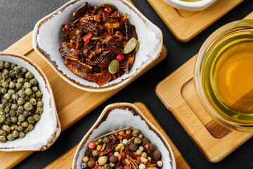 Oil, herbs and spices on wooden background