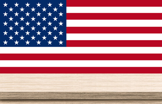 Empty brown wooden table top on american flag background. Use as montage for product display