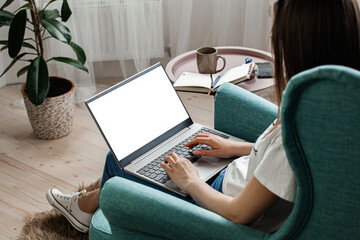 Young woman using laptop to work home, remote work