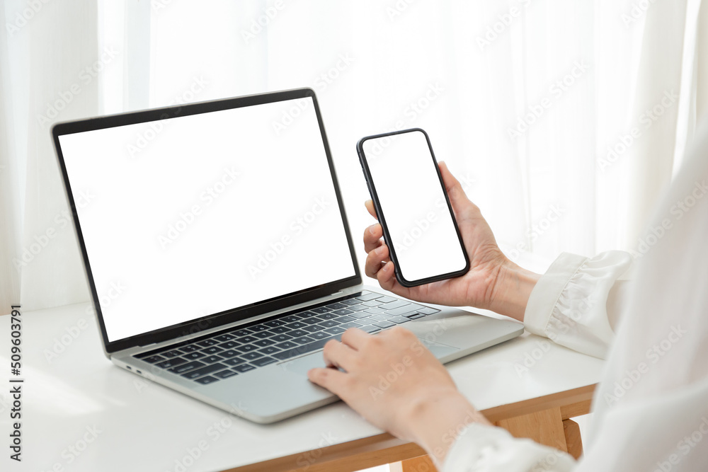 Wall mural computer screen,cell phone blank mockup.hand woman work using laptop texting mobile.white background