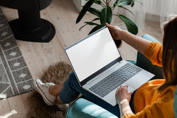 Young woman using laptop to work home, remote work