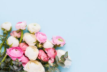 Bouquet of ranunculus flowers on a blue background. Mothers Day, Valentines Day, birthday concept