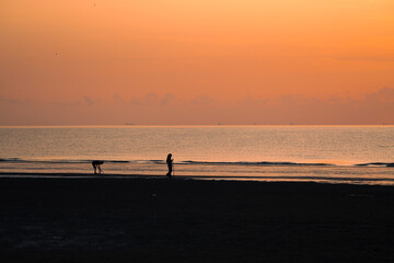 Fototapeta premium Silhouette of walking couple against sunrise..