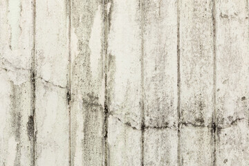 Full frame background of weathered, faded and dirty concrete wall with plaster peeled off for background.