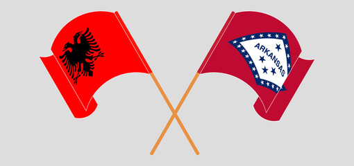 Crossed and waving flags of Albania and The State of Arkansas