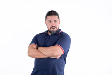 A emotionally hurt man refuses to talk and look straight. Arms crossed. Isolated on a white background.