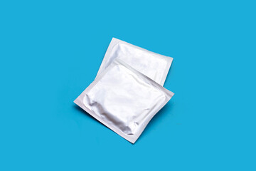 Condom on blue background. Copy space
