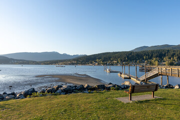 Fototapeta na wymiar Rocky Point Park during sunset time. Long pier over the ocean. Port Moody, BC, Canada.