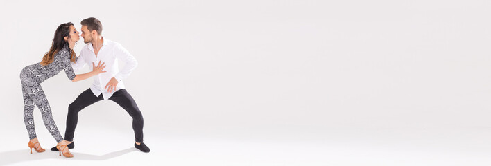 Banner social dance bachata kizomba zouk tango - Man hugs woman while dancing on white background...