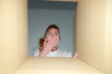 woman is surprised and looks into the box. delivery