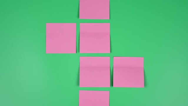 Many note paper on a green background - Stop Motion Animation.