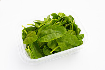 Spinach leaves on white background.