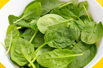 Spinach leaves in white bowl