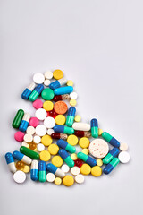 Top view heart made of various pills and tablets. Isoalted on white background.