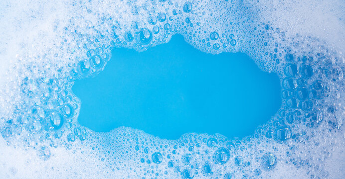 Detergent foam bubble, blue background.