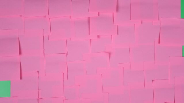 Many note paper on a green background - Stop Motion Animation.