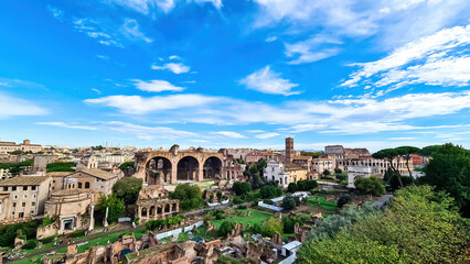 Fototapeta na wymiar Panoramic view from Palatine hill on exterior facade of famous Colosseum (Coloseo) of city of Rome, Lazio, Italy, Europe. UNESCO World Heritage Site. Flavian Amphitheater of ancient Roman Empire