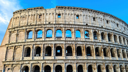 Panoramic view on exterior facade of famous Colosseum (Coloseo) of city of Rome, Lazio, Italy, Europe. UNESCO World Heritage Site. Flavian Amphitheater of ancient Roman Empire. Concept tourism