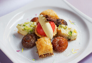 Mixed Turkish Desserts On White Plate, Cookies, Cupcake, Baklava