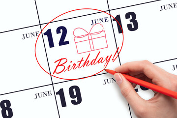 The hand circles the date on the calendar 12 June, draws a gift box and writes the text Birthday. Holiday.
