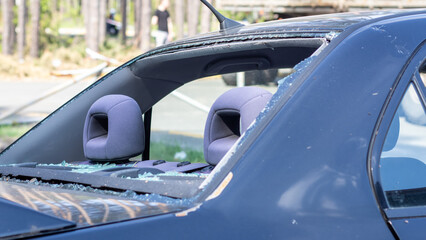 A car after an accident with a broken rear window. Broken window in a vehicle. The wreckage of the...