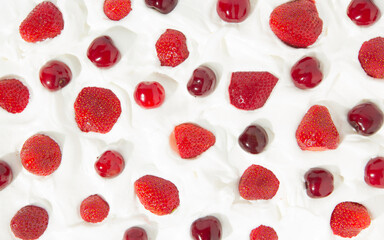 Pattern with fresh strawberries and cherries dipped in whipped cream.